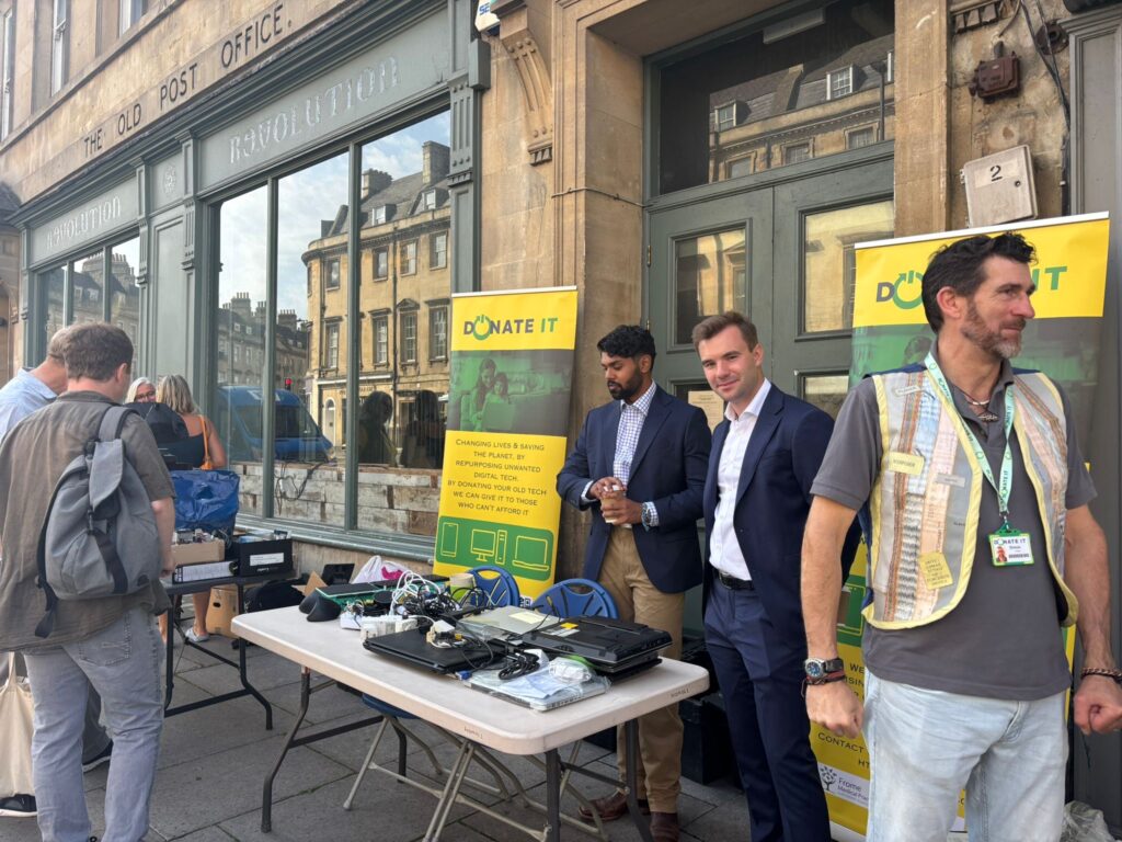 Tech Amnesty July | a group of people around a stall collecting donations of tech