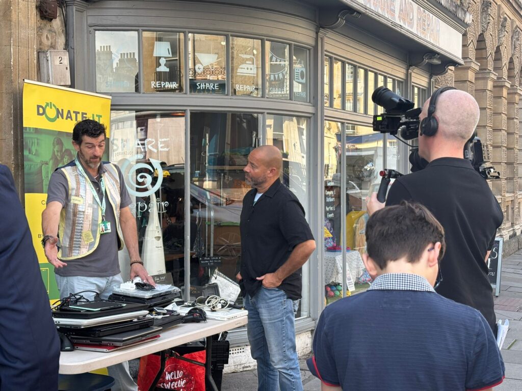 Tech Amnesty July | a cameraman filming a presenter talking to Simon from Donate IT about the Tech Amnesty